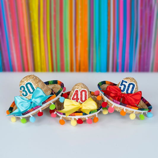 Three sombreros with different colored bows and numbers