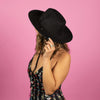 black cowgirl hat on woman