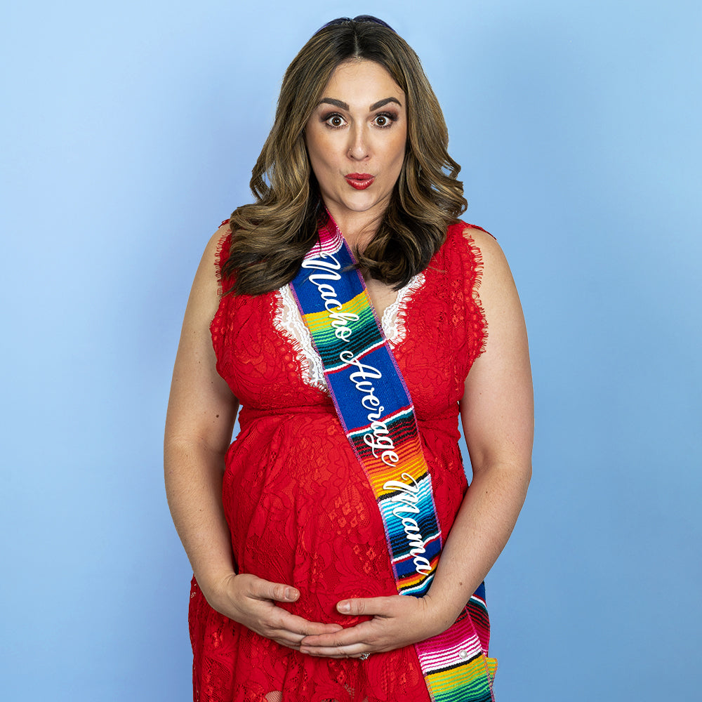 Pregnant woman wearing nacho average mama royal blue serape sash.