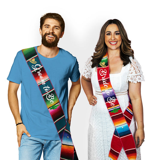 Couple wearing fiesta serape sashes.