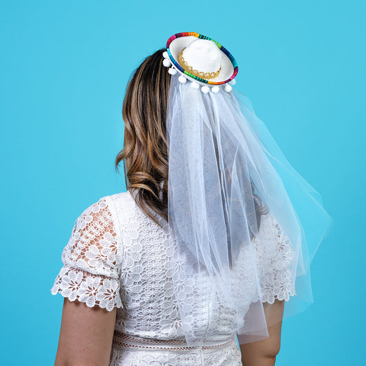 Woman wearing white mini sombrero with plain veil