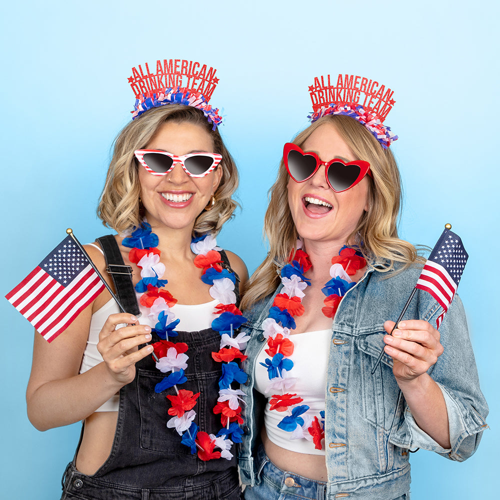 Two young women wearing 4th of July Party headband that says All American Drinking Team
