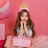 Young girl wearing Gold and pink Birthday Princess Party Headband Crown. Little girl birthday party crown