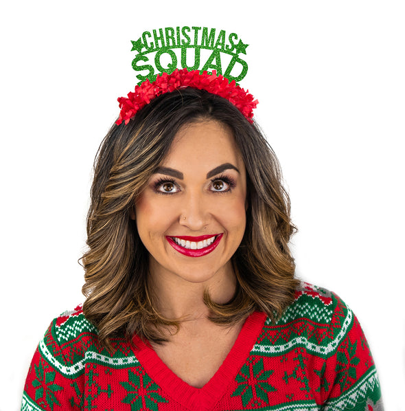 Girl dressed in Christmas sweater wearing a Green glitter party crown with red fringe saying Christmas Squad
