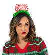 Girl in Christmas sweater wearing a red glitter and green fringe party crown that says "Jolliest Bunch of Assholes"
