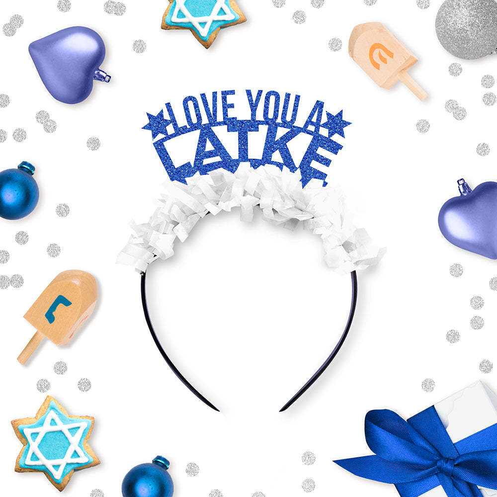 Blue Glitter and White Fringe Party Crown that says "Love You A Latke" surrounded by Hanukkah Decorations
