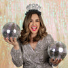 Young woman wearing New Years Eve Party headband saying Pop The Bubbly